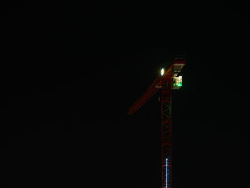 Low angle view of illuminated tower against sky at night