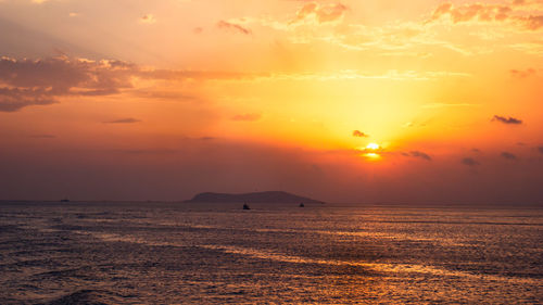 Scenic view of sea against romantic sky at sunset