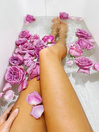 Personal perspective woman in the bathtub full of rose flowers