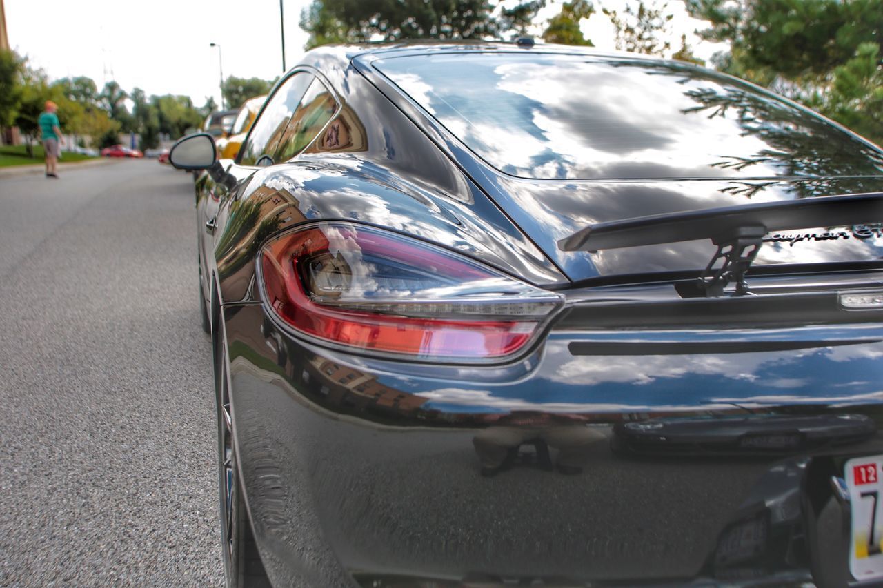 CLOSE-UP OF VINTAGE CAR ON ROAD