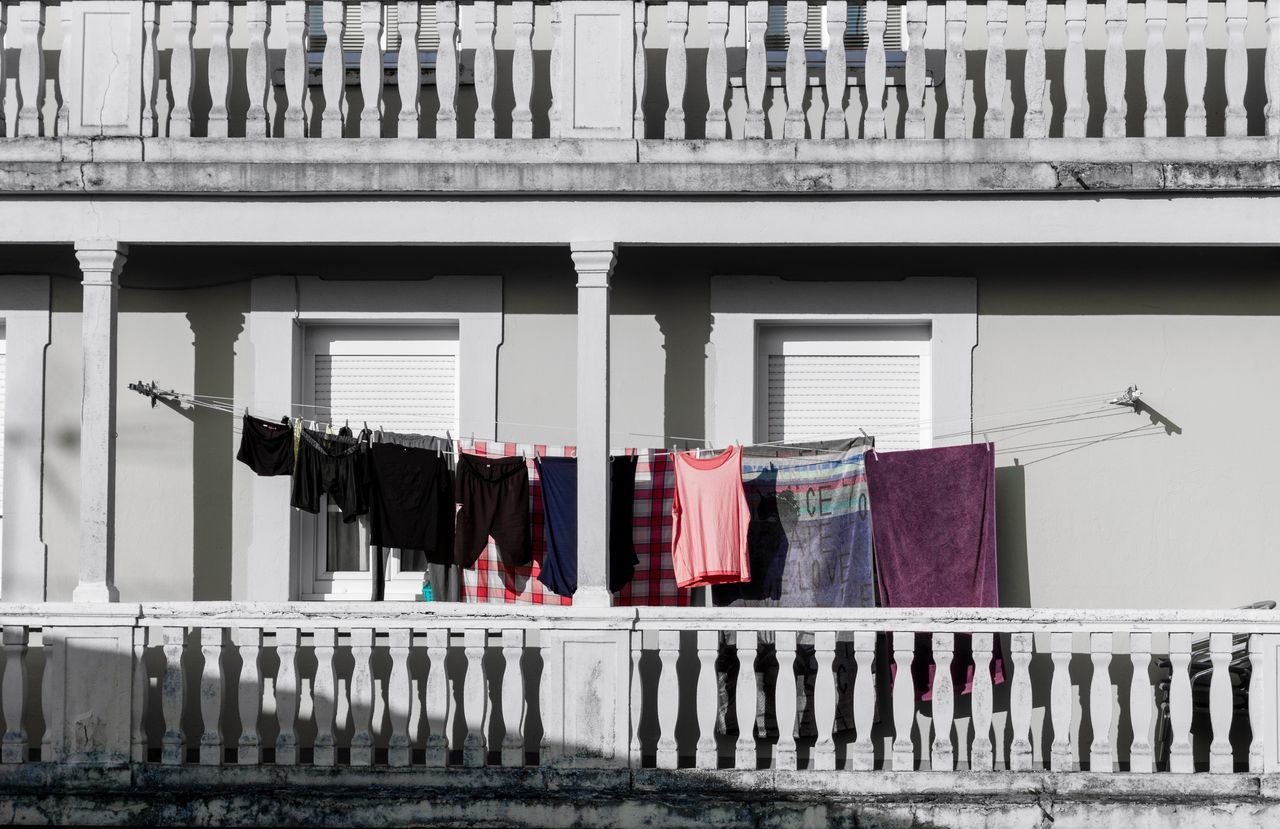 CLOTHES DRYING ON RAILING BY BUILDING