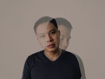 Portrait of young man against white background