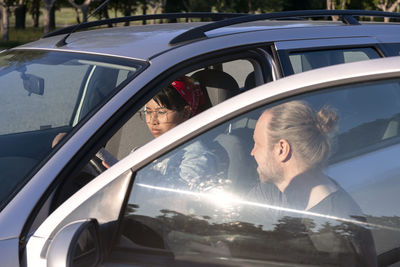 Man teaching woman to drive