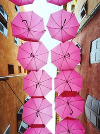 Low angle view of multi colored umbrellas hanging on tiled floor