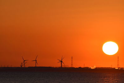 Silhouette of wind turbines at sunset