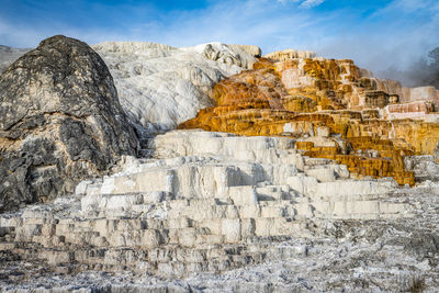 Scenic view of hill against sky