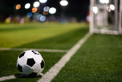 Close-up of soccer ball on field