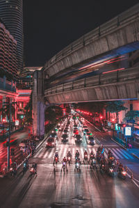 High angle view of traffic on road in illuminated city at night