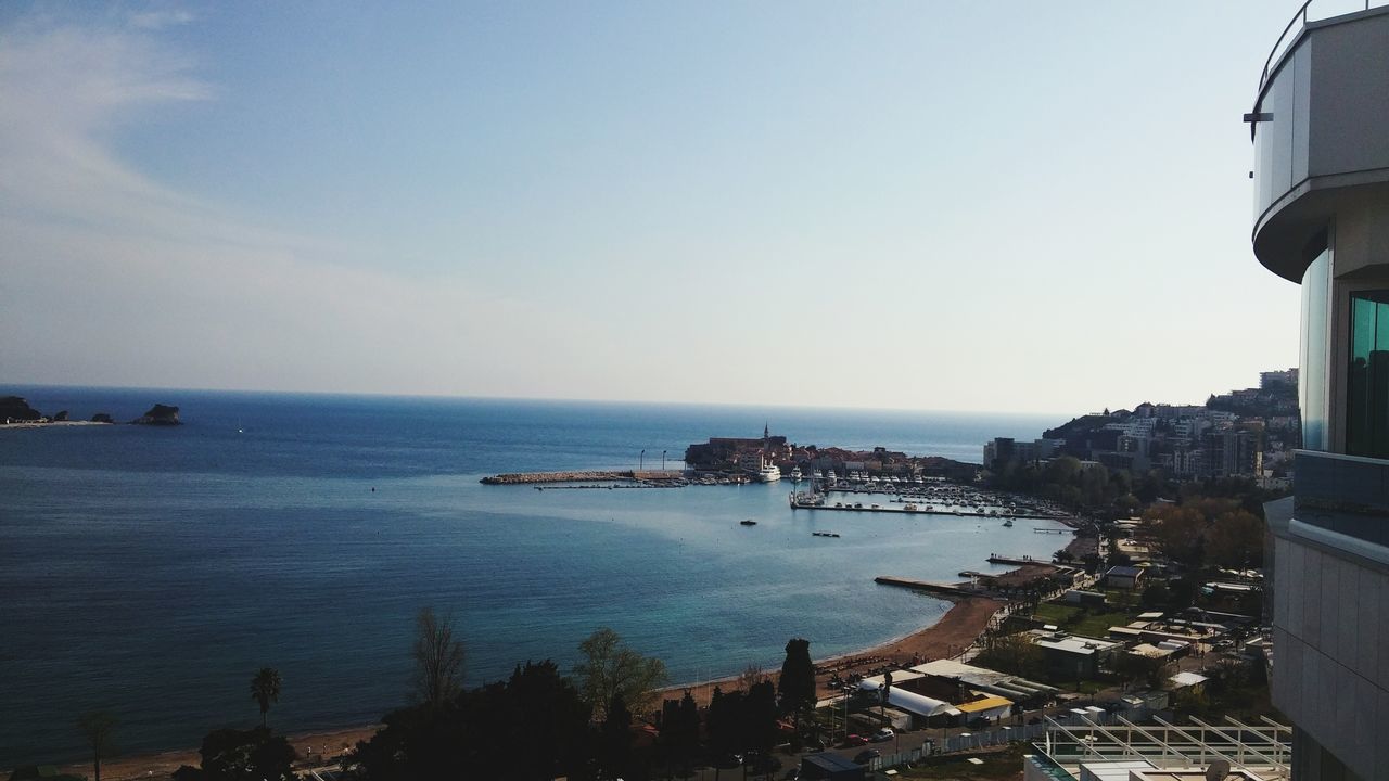 sea, horizon over water, water, built structure, architecture, building exterior, clear sky, copy space, sky, beach, scenics, tranquility, tranquil scene, nature, beauty in nature, shore, coastline, outdoors, blue, incidental people