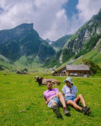 Rear view of woman sitting on field