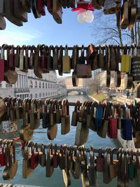 Close-up of padlocks hanging on bridge railing