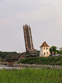 Traditional building on field against sky