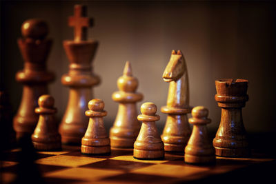 Close-up of wooden chess pieces on board