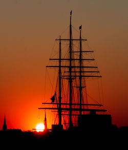 Silhouette of sailboat against sky during sunset