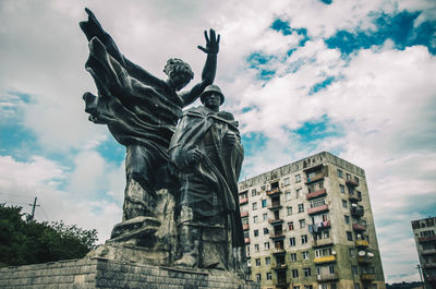 Low angle view of statue against cloudy sky