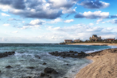 View of beach against cloudy sky