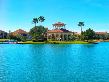 View of swimming pool by building against sky