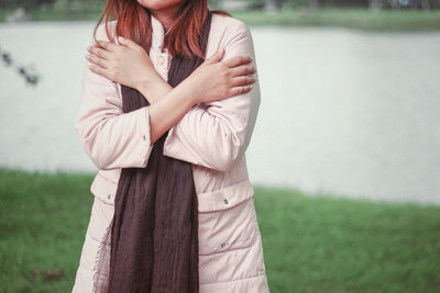 Midsection of woman standing outdoors during winter