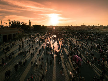 High angle view of people on street in city during sunset