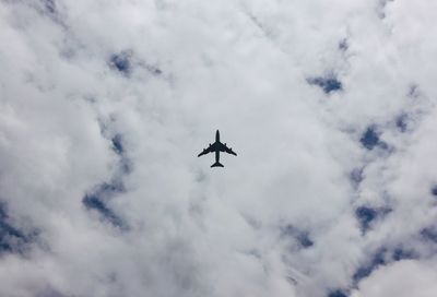 Low angle view of airplane flying in sky