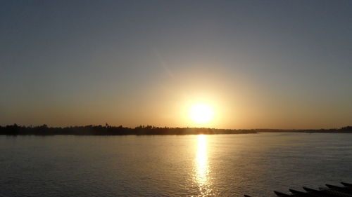 Scenic view of sea against clear sky during sunset