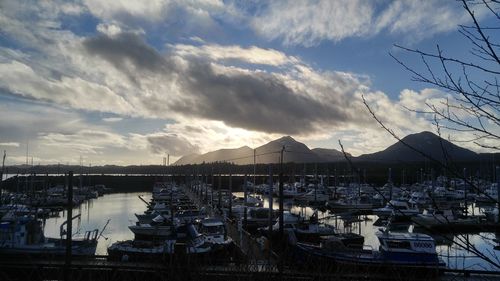 View of harbor against cloudy sky