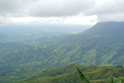 Scenic view of valley and mountains against sky