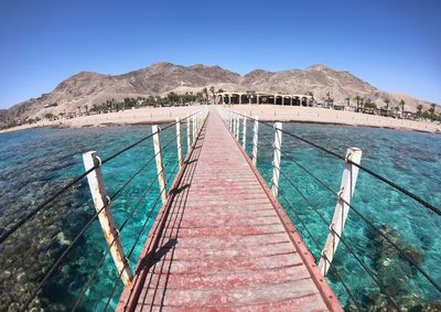 Scenic view of sea against clear blue sky