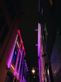 Low angle view of illuminated buildings at night