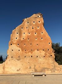 Low angle view of fort against clear blue sky