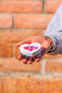 Close-up of hand holding ice cream