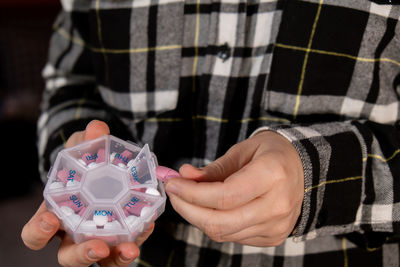 Midsection of woman holding dentures