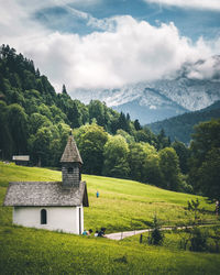 Scenic view of trees and buildings against sky