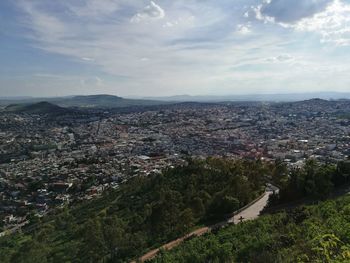 High angle view of town against cloudy sky