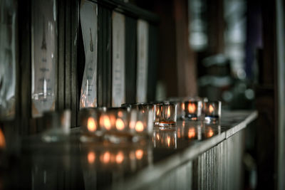 Close-up of illuminated candles in building