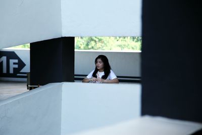 Thoughtful woman standing at parking garage