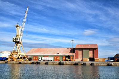 Commercial dock by pier against sky