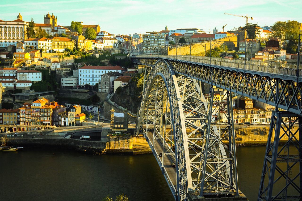 architecture, building exterior, bridge - man made structure, built structure, city, travel, transportation, connection, travel destinations, sky, river, outdoors, cityscape, no people, ferris wheel, day, cultures, water