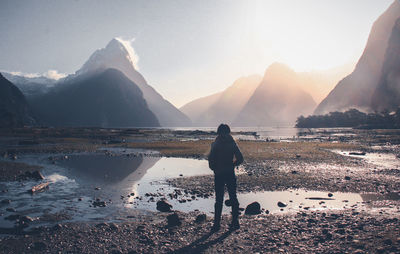 A woman standing at milford sound new zealand.