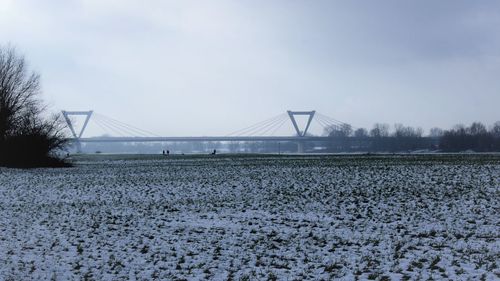 Scenic view of field against sky during winter