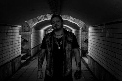 Portrait of young man standing in tunnel