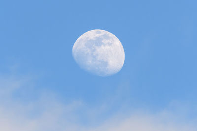 Low angle view of moon against blue sky