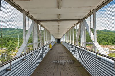 Diminishing perspective view of empty overpass with protective metal fence