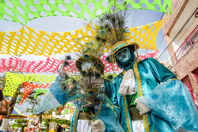Two people wearing carnival mask