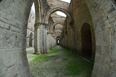 Pathway seen through arch of old building