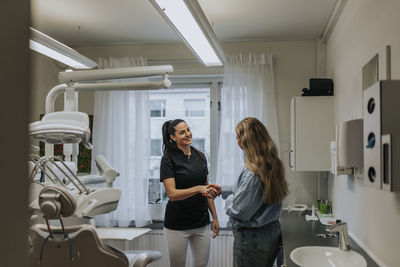 Female dentist with patient in dentist's office