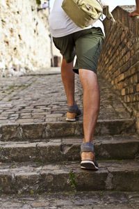 Low section of woman walking on steps