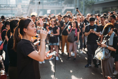 Group of people enjoying music in city