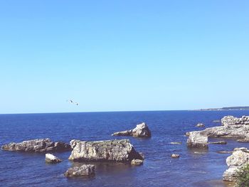 Scenic view of sea against clear blue sky