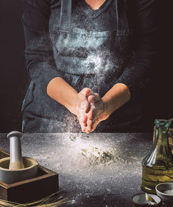 Midsection of man preparing food on table